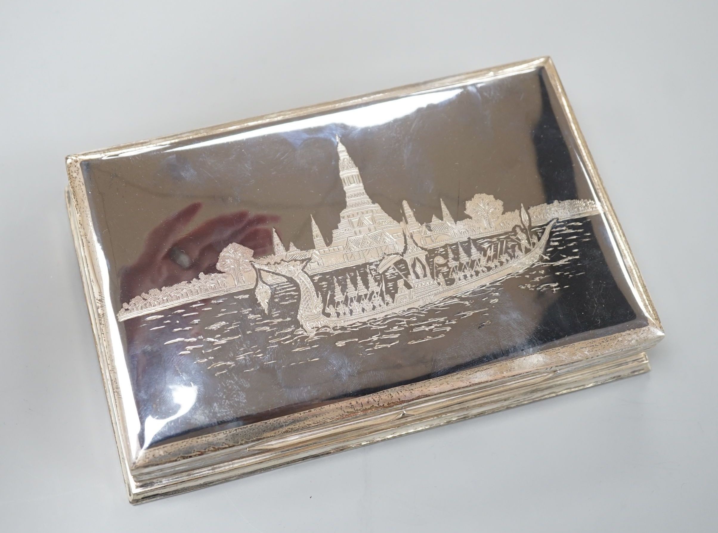 A Siamese sterling and niello cigarette box, 18.7cm.